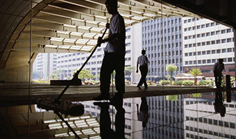 ca. October 1995, Makati, Manila, Philippines --- Janitor in the Philippine Stock Exchange Building --- Image by © Catherine Karnow/CORBIS